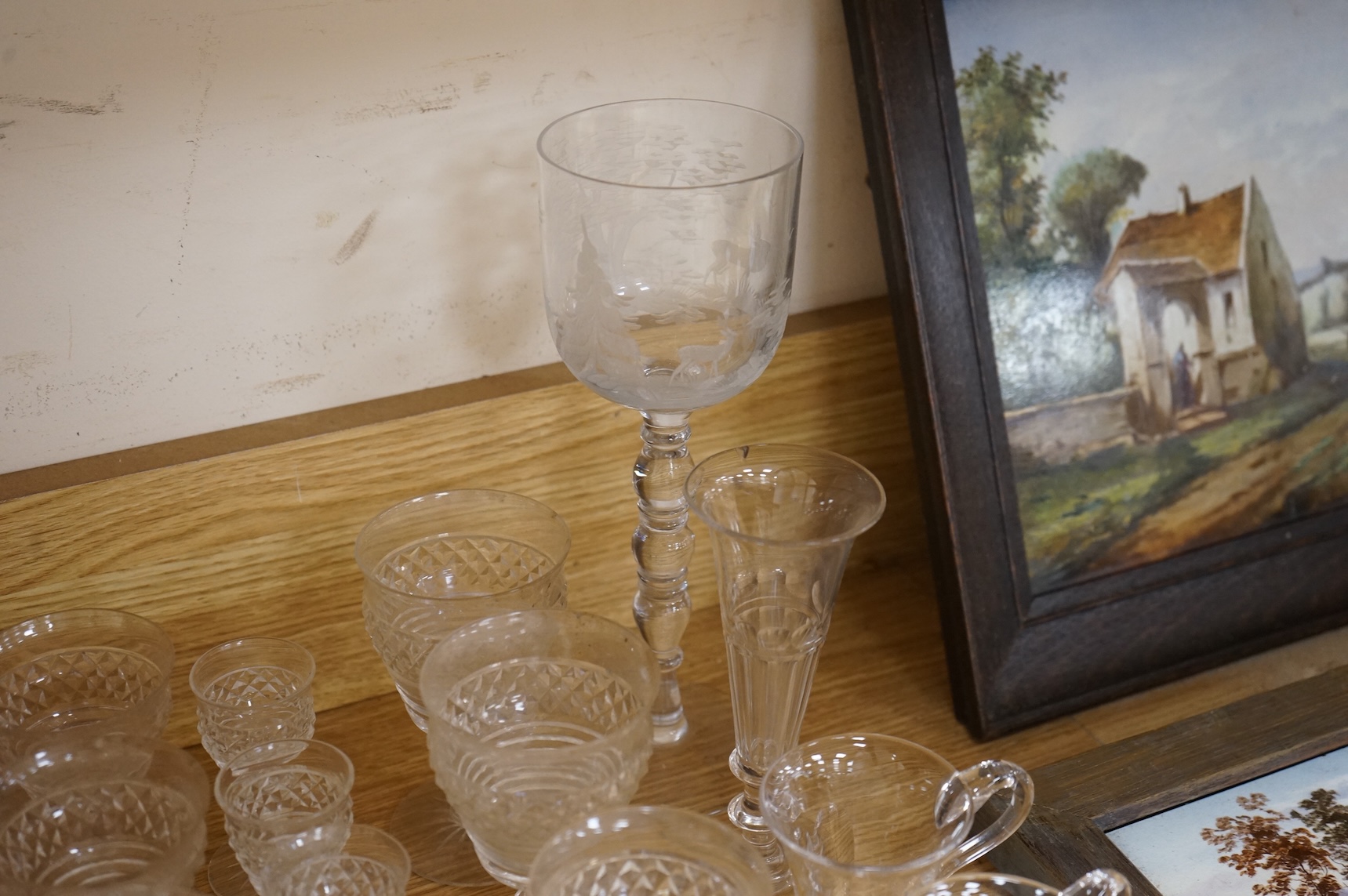 A suite of early 20th century cut table glass, custard glasses, a tall stemmed etched glass, etc., etched glass 24cm high